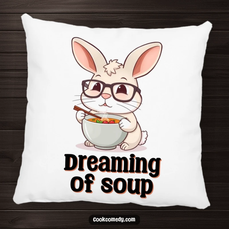 A soft pillow depicting a funny rabbit chef with large glasses carefully tasting a tiny bowl of steaming soup.