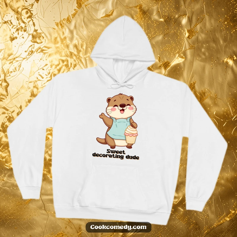 A cozy hoodie featuring a funny otter baker with an apron gleefully decorating a miniature cupcake.