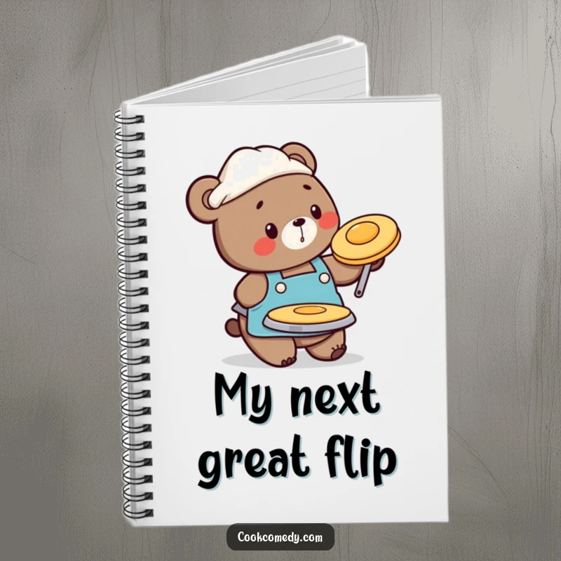 Funny notebook with a busy bear chef in an apron, flipping a pancake, ideal for jotting down recipes.
