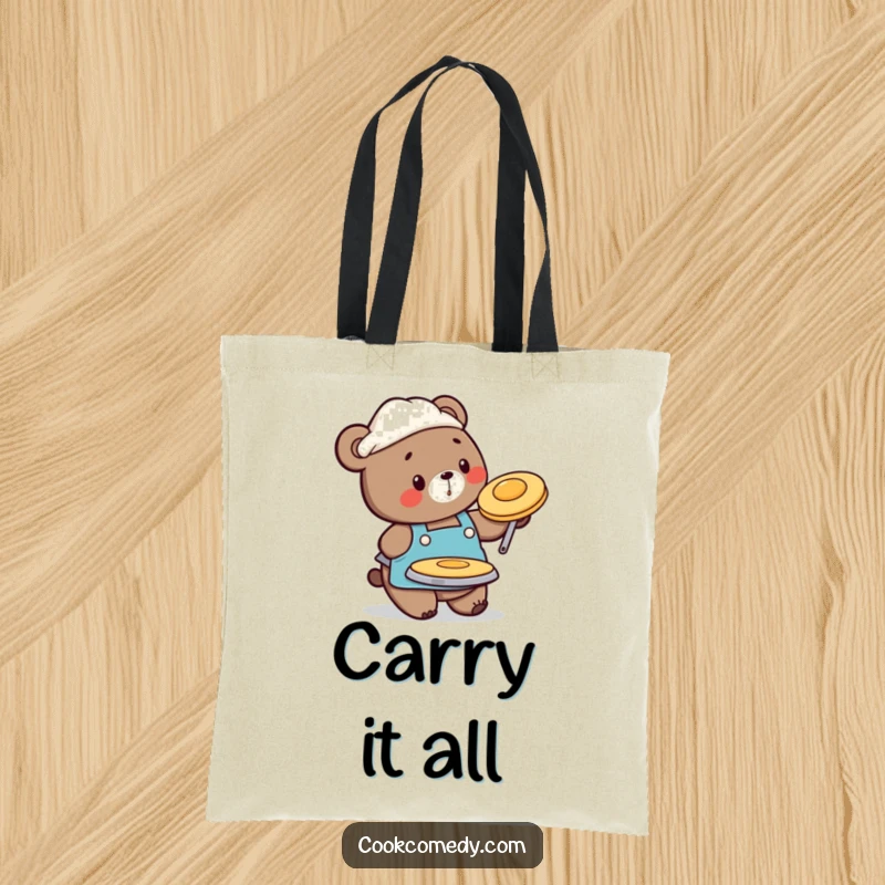 Funny tote bag with a busy bear chef in an apron, flipping a pancake, ideal for carrying essentials with a smile.